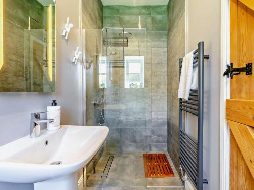 a bathroom with a tub and a sink and a shower at 2 Bed in Belford oc-92196 in Ellington