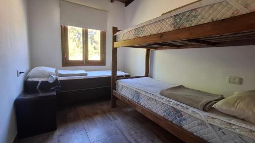 a bedroom with two bunk beds and a window at Duplex La Caleta Mar in Mar de Cobo