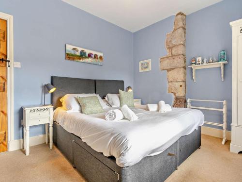 a bedroom with a large bed with blue walls at 3 Bed in Belford oc-cn022 in Smeafield