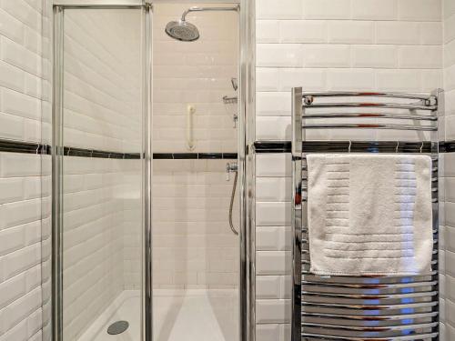 a bathroom with a shower and a towel on a rack at 3 Bed in Belford oc-cn022 in Smeafield