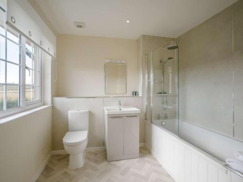 a bathroom with a toilet and a shower and a sink at 2 Bed in Mindrum oc-85422 in Carham