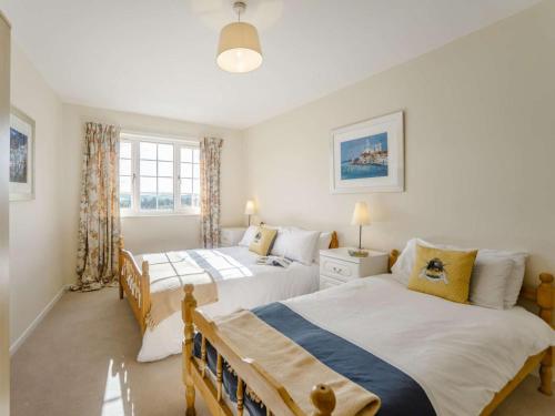 a bedroom with two beds and a window at 2 Bed in Mindrum oc-85422 in Carham
