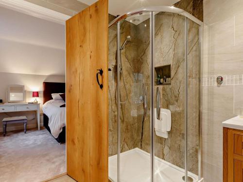 a shower with a glass door in a bathroom at 1 Bed in Chard oc-91135 in Cudworth