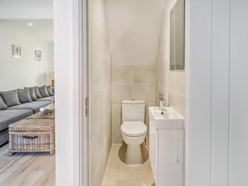 a bathroom with a toilet and a sink and a couch at 3 Bed in Shanklin oc-92052 in Shanklin