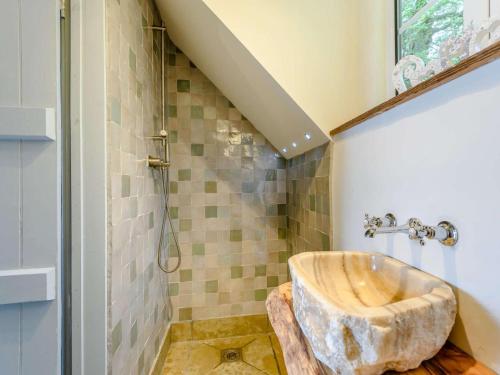 a bathroom with a stone sink and a shower at 4 Bed in Salisbury oc-82799 in Winchester