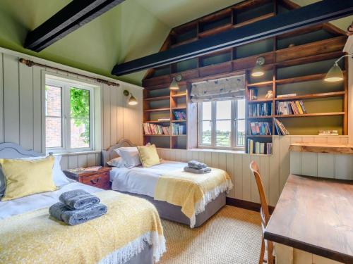a bedroom with two beds and a book shelf at 4 Bed in Salisbury oc-82799 in Winchester