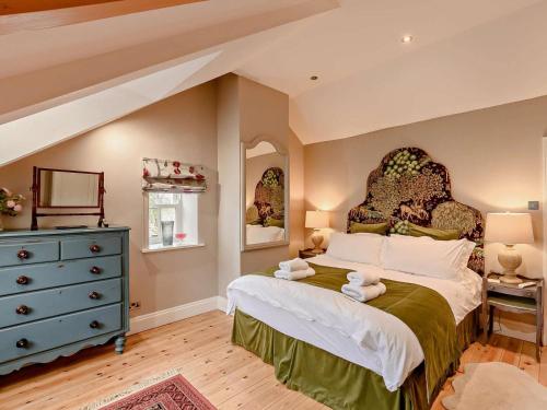 a bedroom with a large bed and a blue dresser at 3 Bed in Morpeth oc-61257 in Harbottle