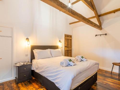 a bedroom with a large bed with towels on it at 4 Bed in Hexham oc-78159 in Catton