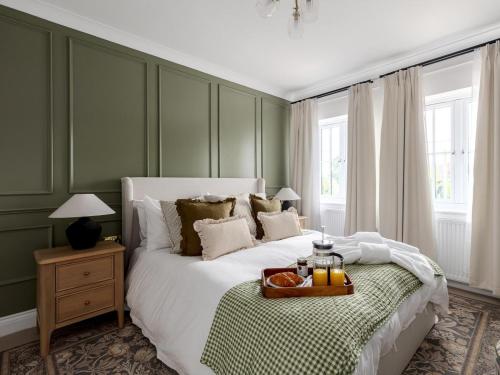 a bedroom with a bed with a tray of food on it at 5 Bed in Lymington oc-96189 in Sway