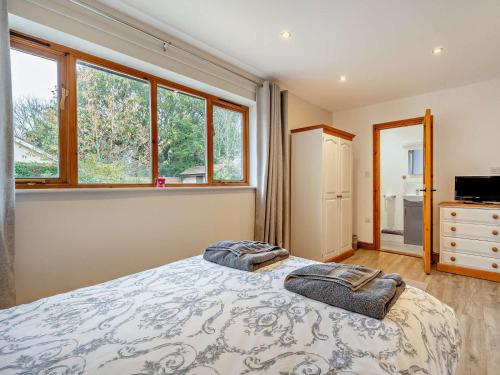 a bedroom with a bed with two pillows on it at 3 Bed in Wareham oc-dc157 in Stoborough