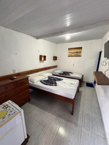a bedroom with two beds in a room at Hotel D'Aldeia Cametá in Cametá