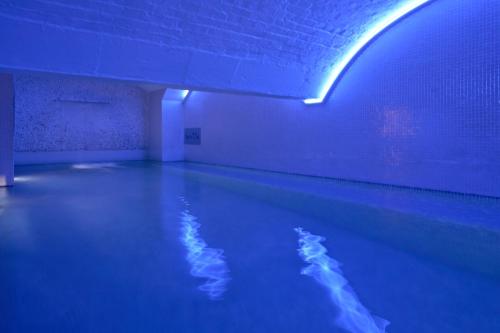 a pool of water in a room with blue lights at Harbour Hotel & Spa Bristol in Bristol