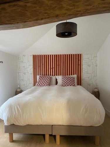 a bedroom with a large white bed with pillows at Sylo-V CHAMBRE EDGAR in Gensac-la-Pallue