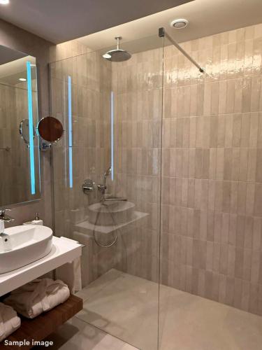 a bathroom with a glass shower and a sink at ROBINSON BOA VISTA - All inclusive in Sal Rei