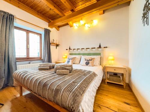 a bedroom with a bed with two pillows on it at Belvedere Solferino panoramic view in Campolongo