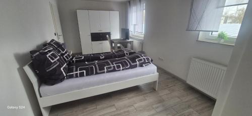 a bedroom with a bed with a mirror and a table at Ilo's Zimmervermietung in Stadtallendorf