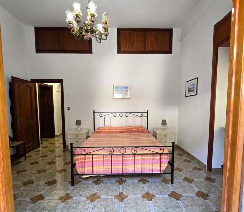 a bedroom with a bed and a chandelier at Rosa Dei Venti in Amalfi