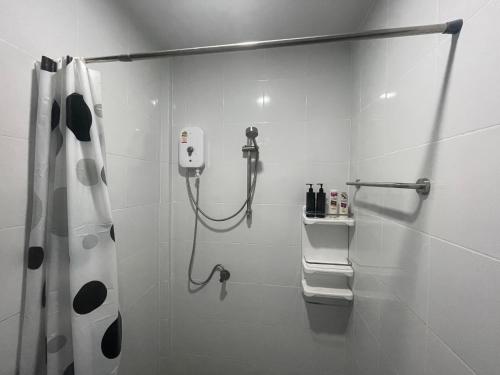 a white bathroom with a shower with a shower curtain at Butterfly Home Mai Khao Phuket in Ban Suan Maphrao
