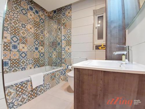 a bathroom with a sink and a toilet at Seafront Apt Mellieha with Stunning Sea Views in Is-Sellum
