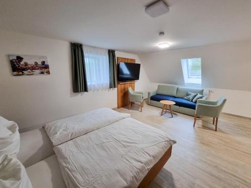 a bedroom with a bed and a couch at Apartment "Storch" in Wehlenberg
