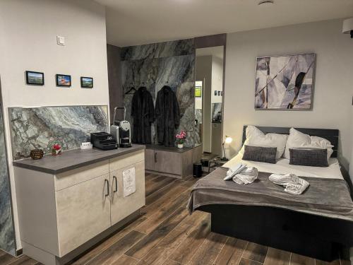 a bedroom with a large bed and a counter at Day SPA Design Muhr in Wehlenberg