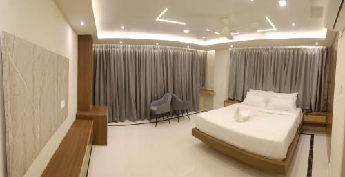 a bedroom with a bed and a desk and a chair at Hotel High Rise in Kolkata