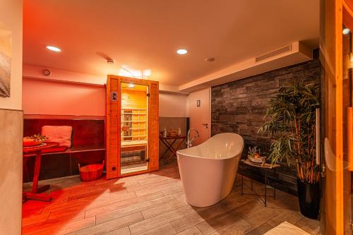 a large bathroom with a tub and a sink at Day SPA Streudorf in Muhr amSee