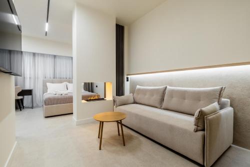a living room with a couch and a bed at Xanthia Suites in Xanthi