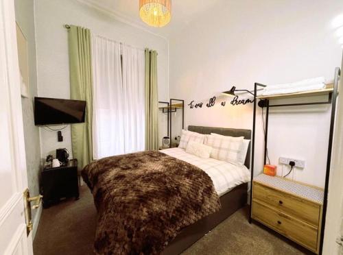 a bedroom with a bed and a sign that reads just in a bedroom at 16 Pilrig Guest House in Edinburgh