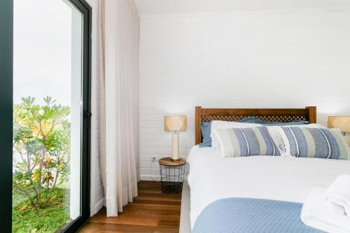 a bedroom with a bed and a large window at GuestReady - Good Vibes in Ponta Delgada
