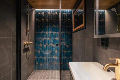 a bathroom with a shower and a sink at Lapland Glow Chalets in Rovaniemi