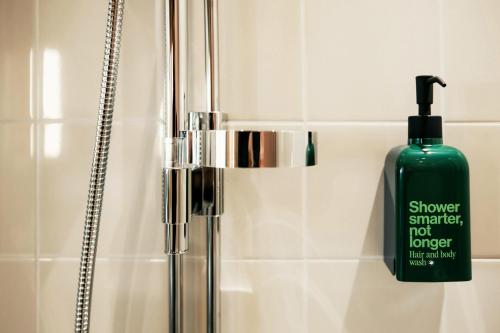 a bottle of shower simpler not longer soap in a bathroom at Scandic Go, Saaristonkatu 1 in Oulu