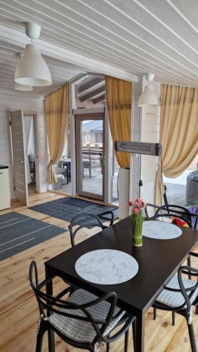 a dining room with a black table and chairs at Scandidim Lutsk in Lutsk