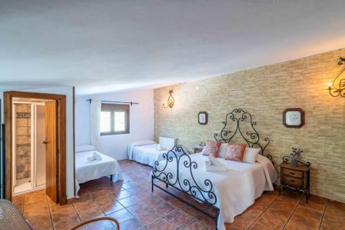 a hotel room with a bed and a bedroom at El Acebuchal de Ubrique in Ubrique
