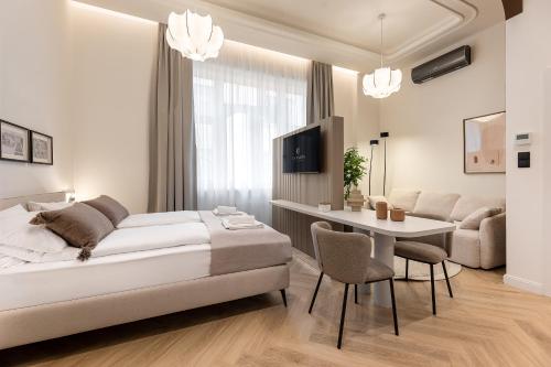 a bedroom with a bed and a table and chairs at Catalog Boutique Rooms Debrecen in Debrecen