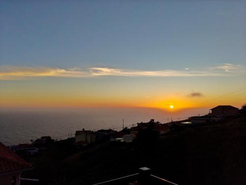 a sunset over the ocean with the sun in the sky at Golden Sun Refugio -Calheta in Estreito da Calheta