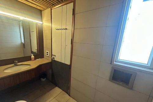 a bathroom with a sink and a mirror at Premium Nest, Golf Course Road in Gurgaon