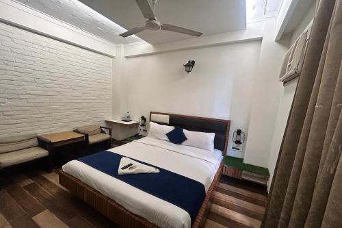 a bedroom with a bed with a ceiling fan at Premium Nest, Golf Course Road in Gurgaon