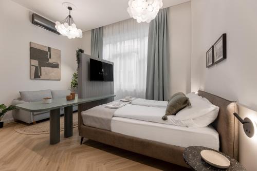a bedroom with a bed and a table and a couch at Catalog Boutique Rooms Debrecen in Debrecen
