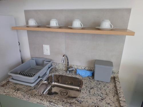 a kitchen counter top with a sink and a sink at Flat em Tamandaré - 102 - Carneiros Beach Exclusive in Tamandaré