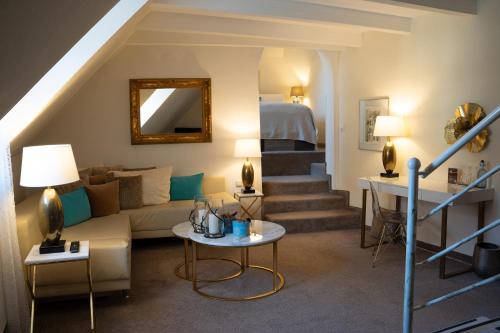 a living room with a couch and a table at Drahthammer Schlößl in Amberg