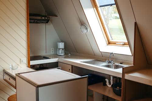 a small kitchen with a sink and a window at Sport- und Ferienpark Worriken in Butgenbach