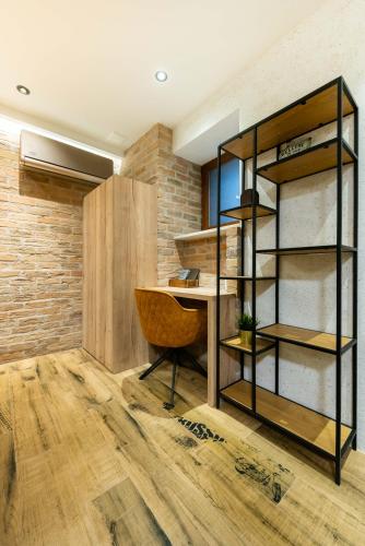 a room with a desk and a chair at Deluxe Dino room & studio apartment by Adex travel in Zadar