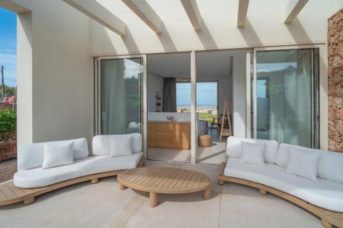 a living room with two white couches and a table at Villa Gypsy by Aura Collection in Tindaya