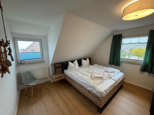 a bedroom with a bed and a chair in it at Ferienhaus Windberg in Sassnitz