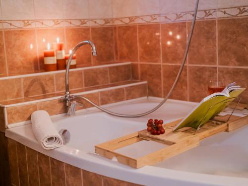a bath tub with a bird sitting on top of it at A MI KISHÁZUNK vendégház in Szomód