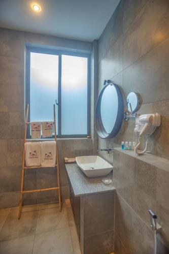 a bathroom with a sink and a mirror at Amera Hiriketiya in Dickwella