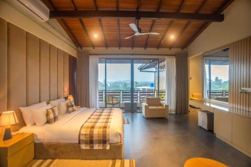 a bedroom with a bed and a large window at Amera Hiriketiya in Dickwella