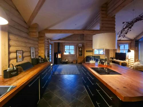 a kitchen with a wooden counter top in a room at Round Timber House In Forest Near Mariager in Hadsund