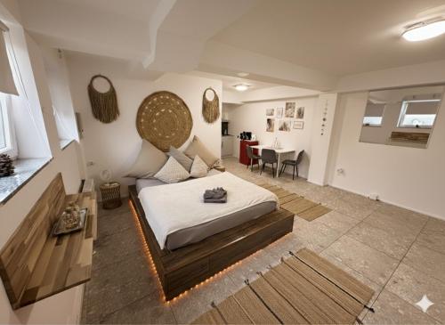 a bedroom with a bed and a dining room at BOHO Apartment Auréa nähe Salzburg in Freilassing